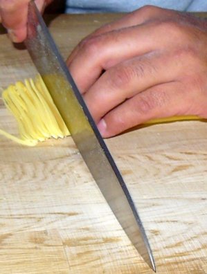 Martin Islas cuts pasta.JPG